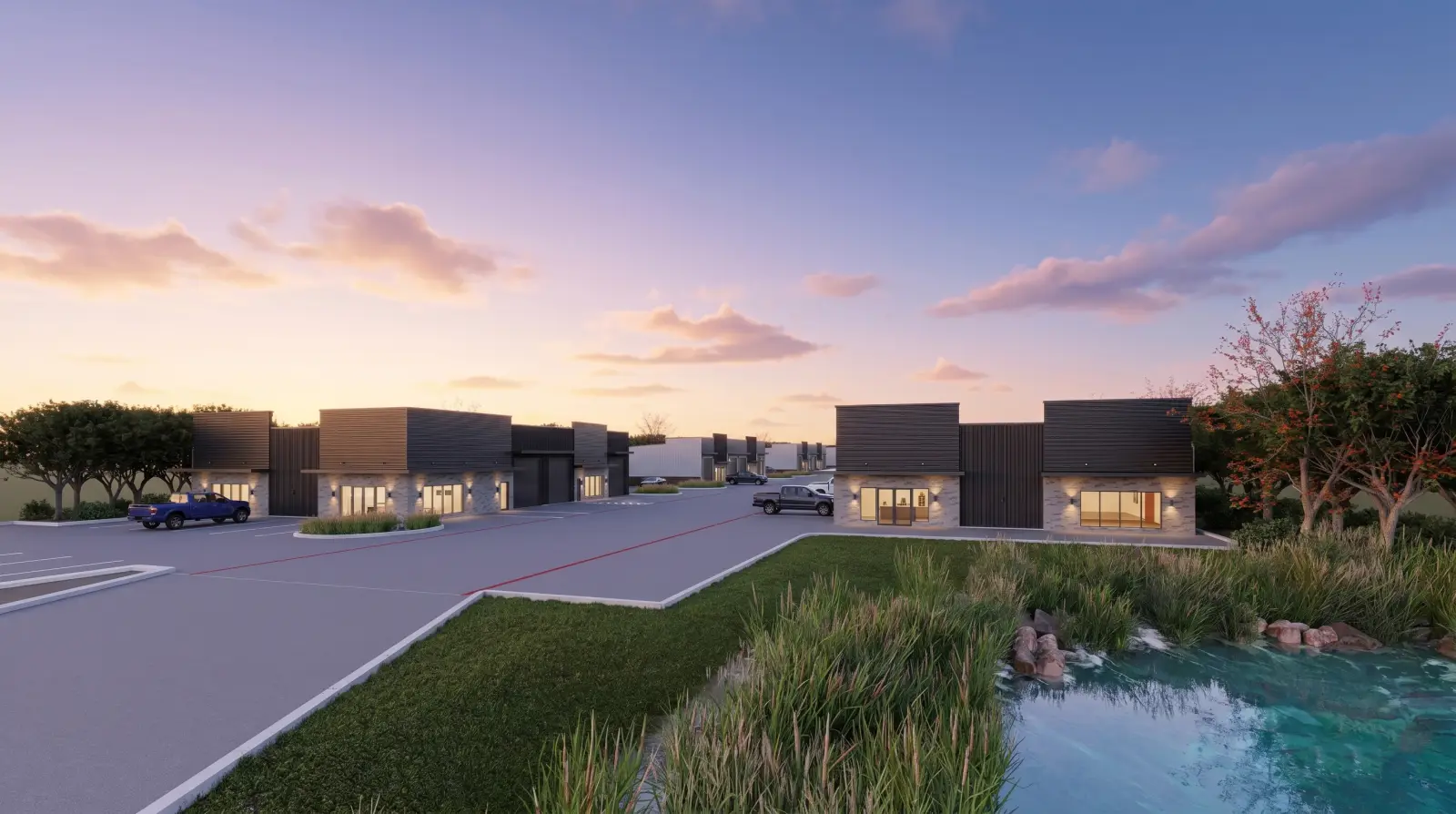 Rockwall Flex Park at dusk, looking across the detention pond toward the showroom fronts