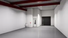 2,000 SF warehouse bay with grade-level roll-up door and utility sink